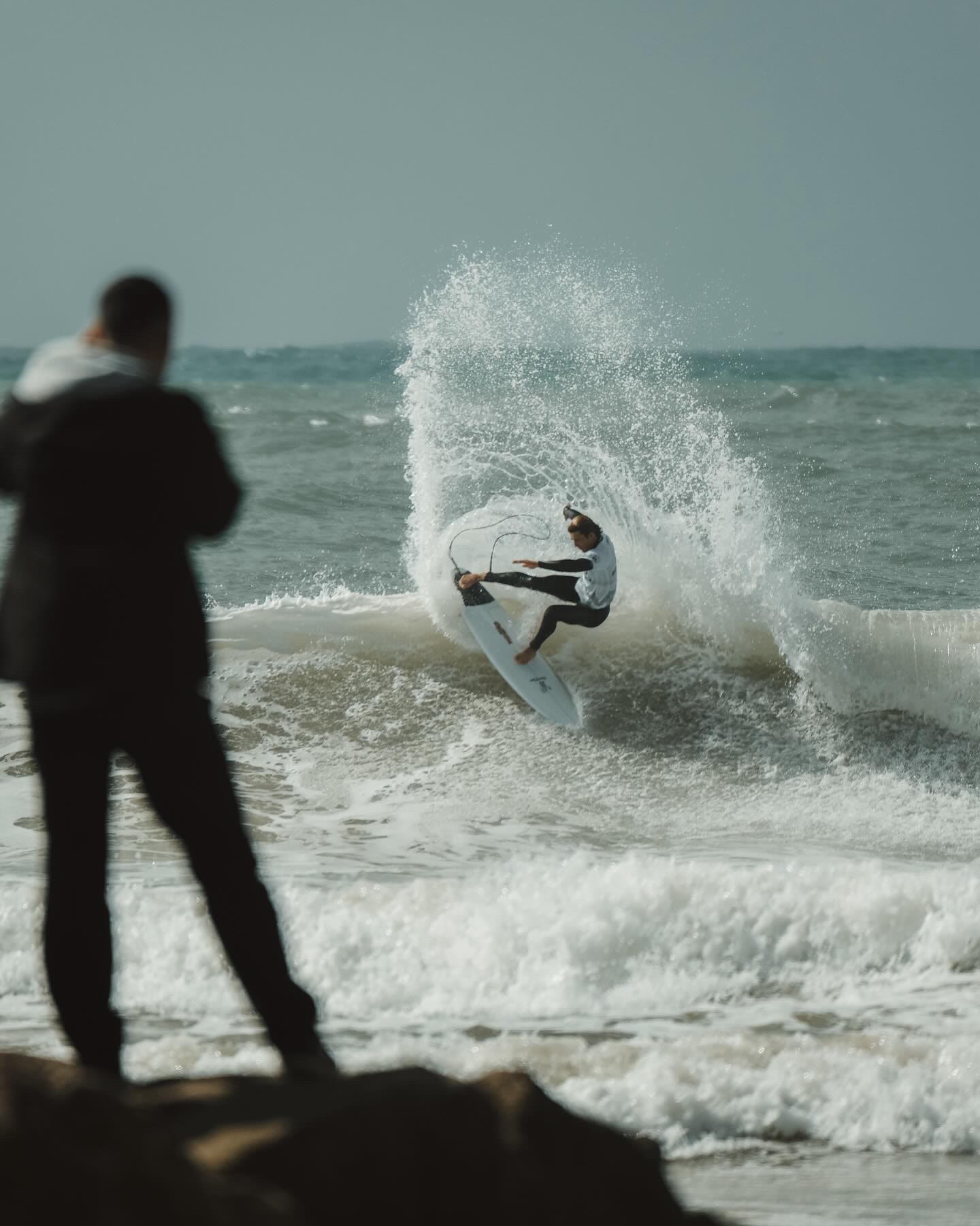 Surfer on the beach at sunset