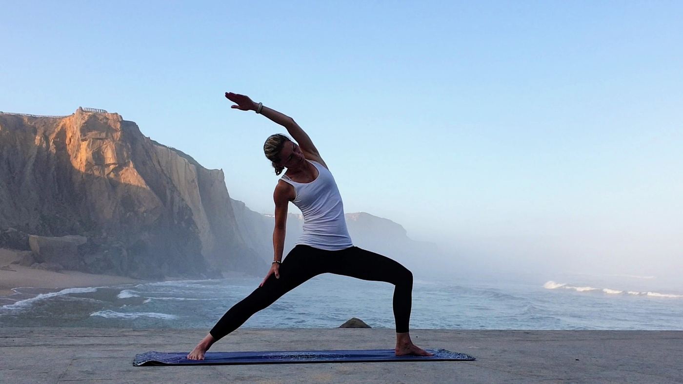 Yoga on the sand below the cliffs at Santa Cruz