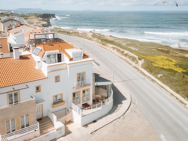 The PKSC house above the coast road, with the ocean behind it
