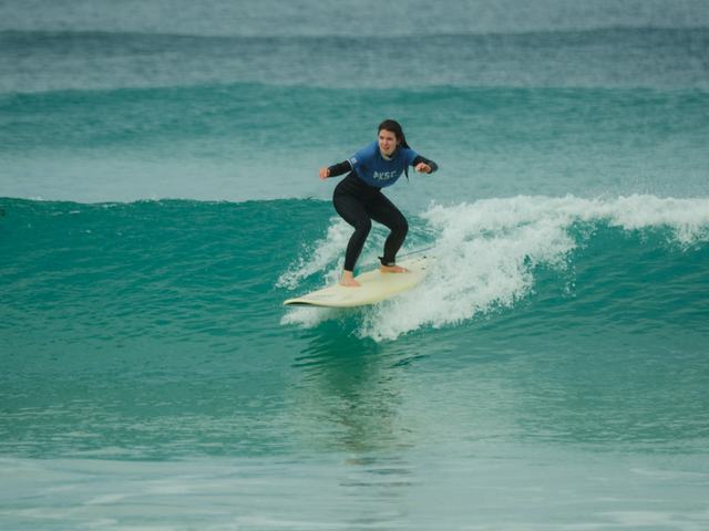 A surfer riding a clean green wave
